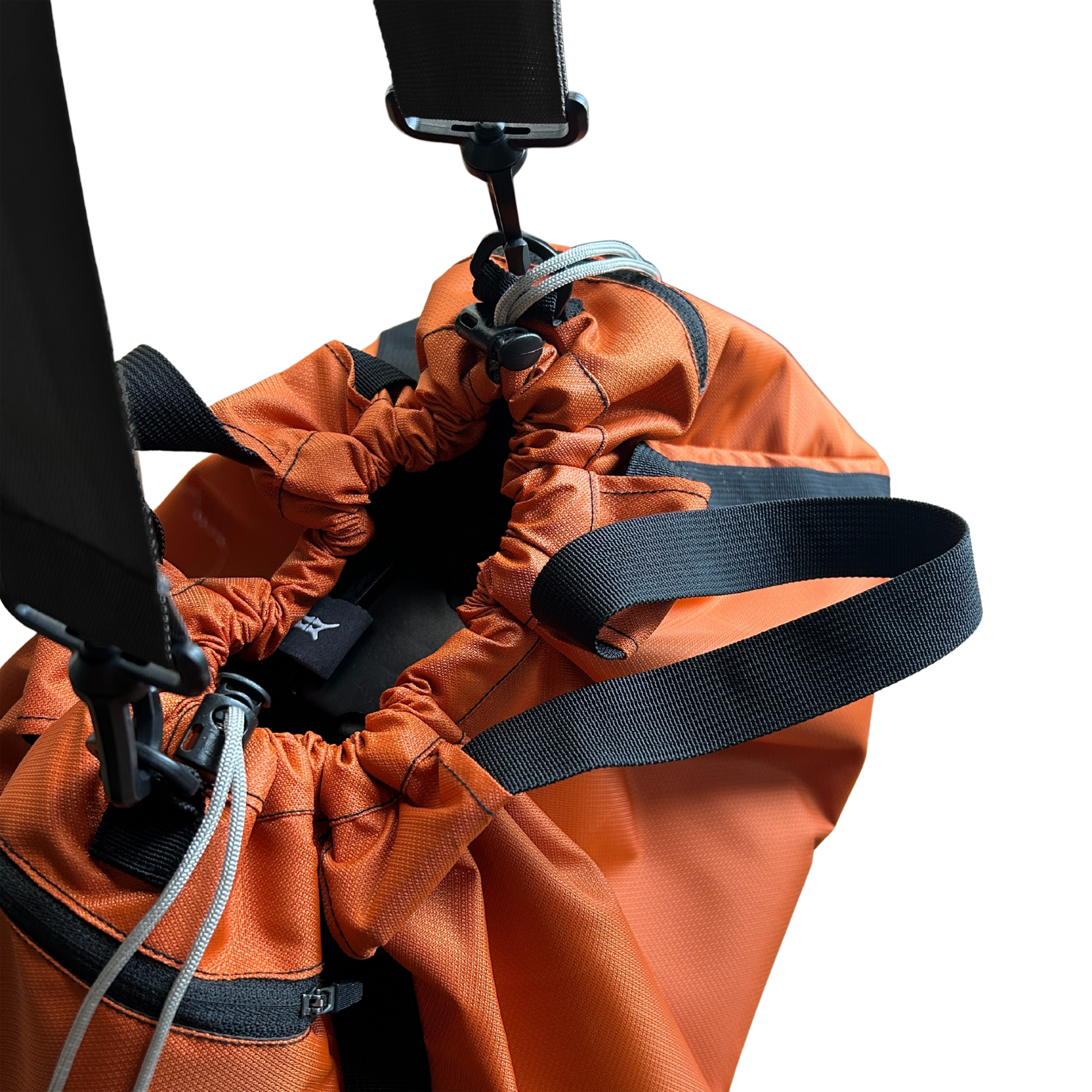Close-up of an orange nylon gym bag, showing the drawstring opening and detachable strap clip.