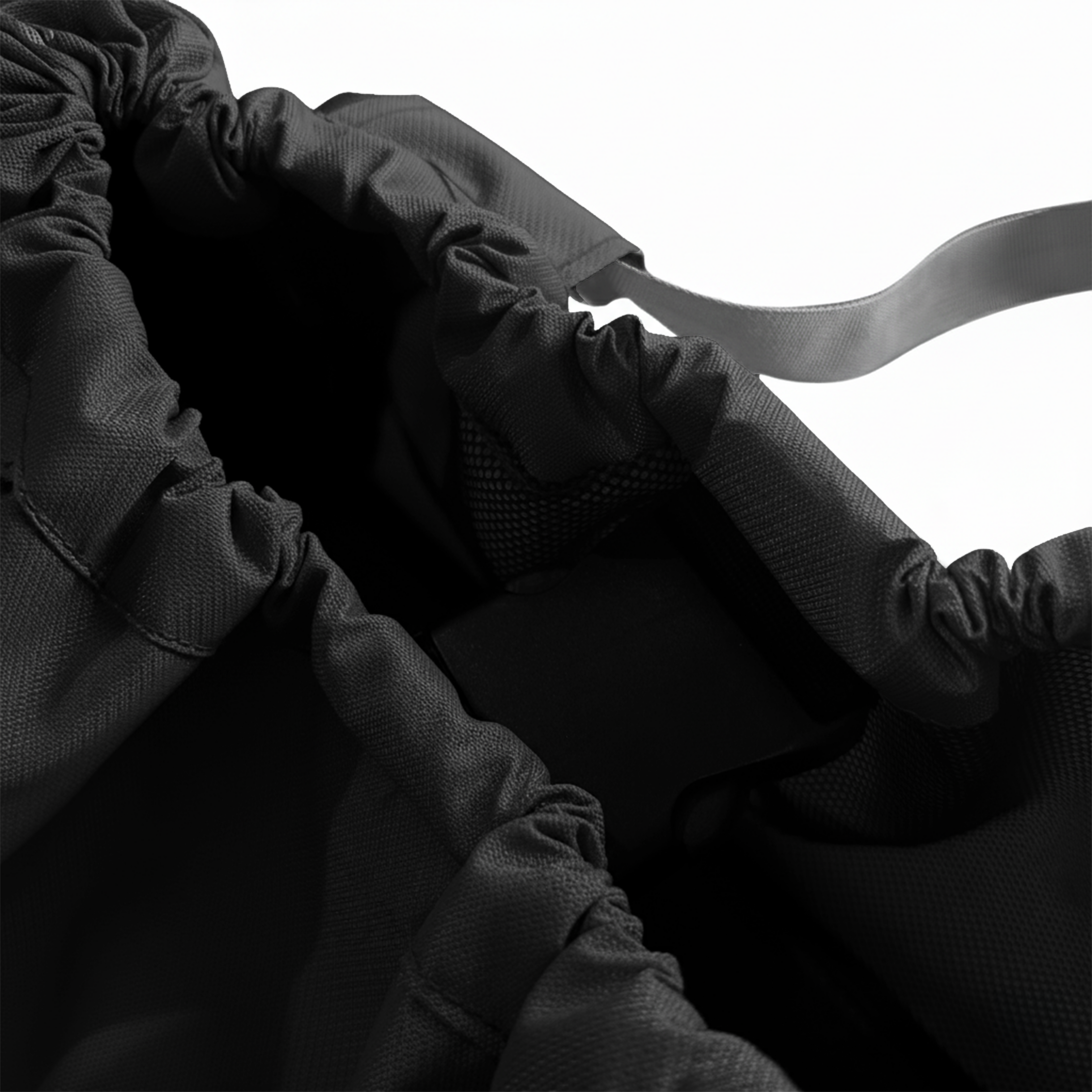 Top-down view into a black nylon gym bag, showing the spacious dark interior.