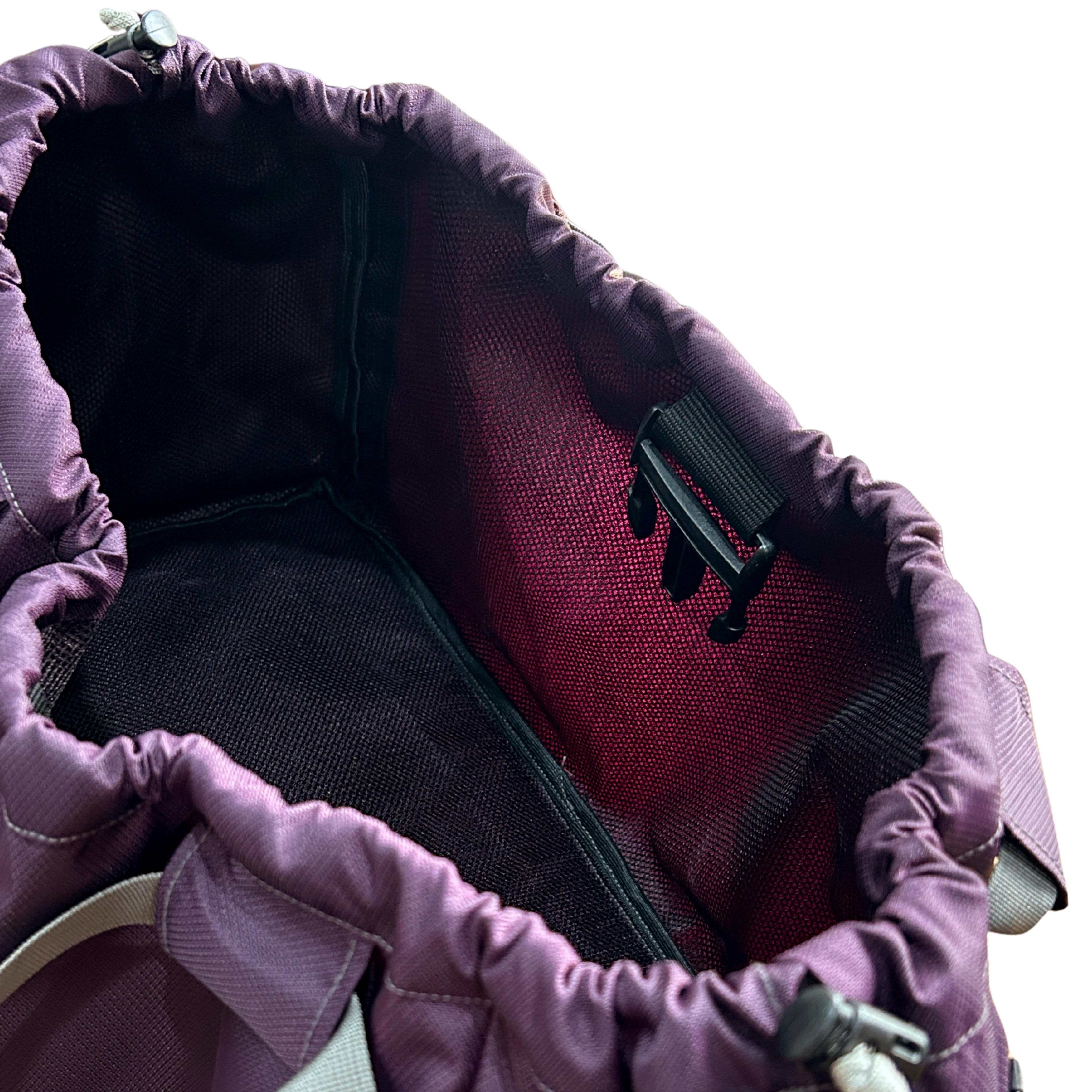 Top-down view into a purple nylon gym bag, showing the spacious mesh interior and key clip.
