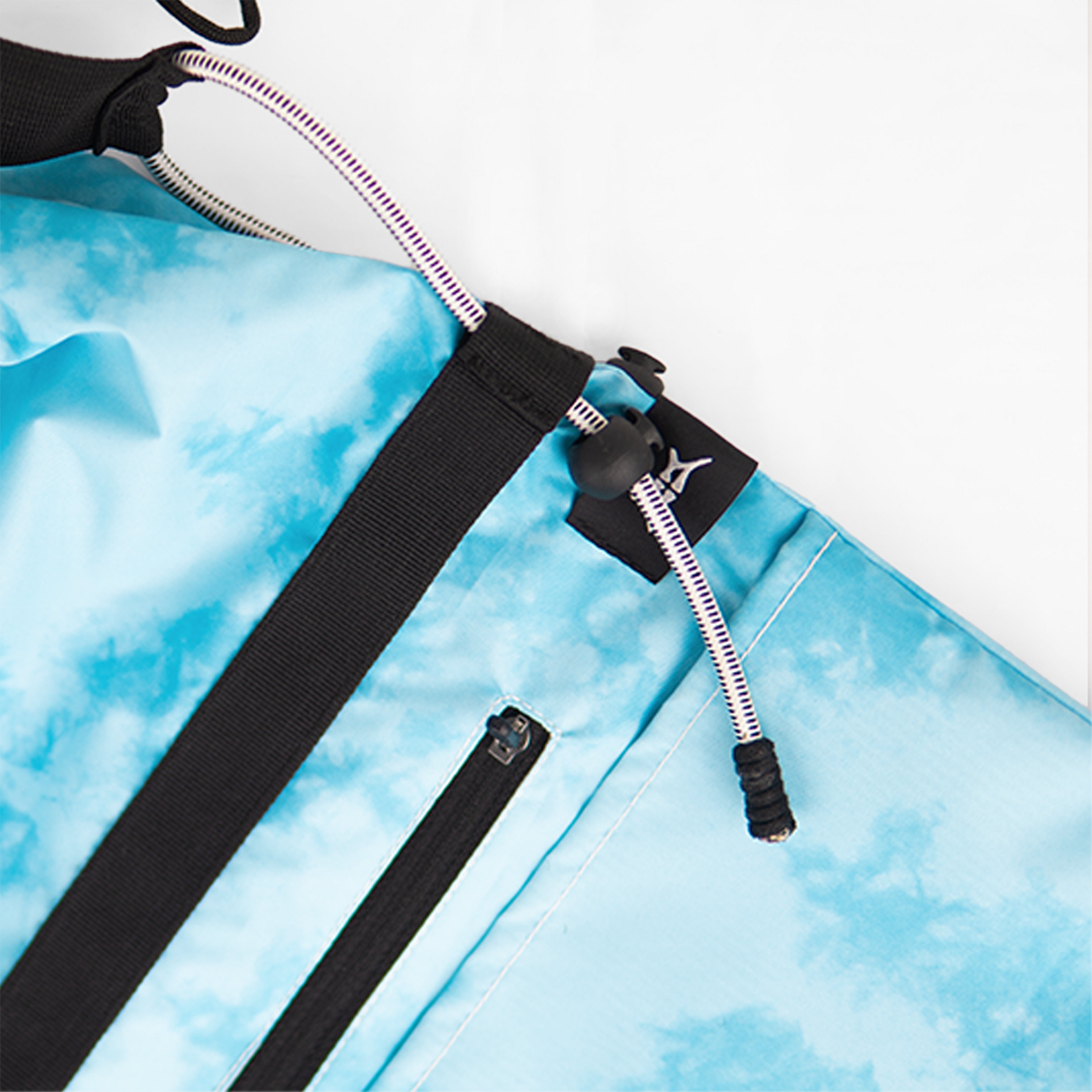 Detailed view of a tie-dye blue water-resistant crossbody bag with a zippered pocket.
