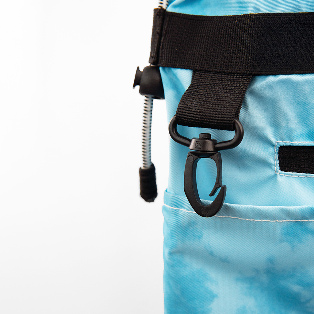 Close-up of a tie-dye blue water-resistant sling bag's durable hook and strap.